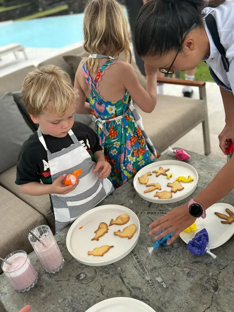 A child decorating cookies in the lodge kitchen