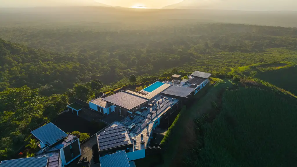 Coastal Galápagos highlands overlooking a turquoise bay with a yacht