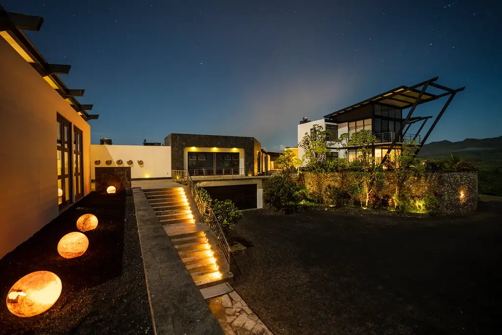 Pikaia Lodge at night with illuminated pathways
