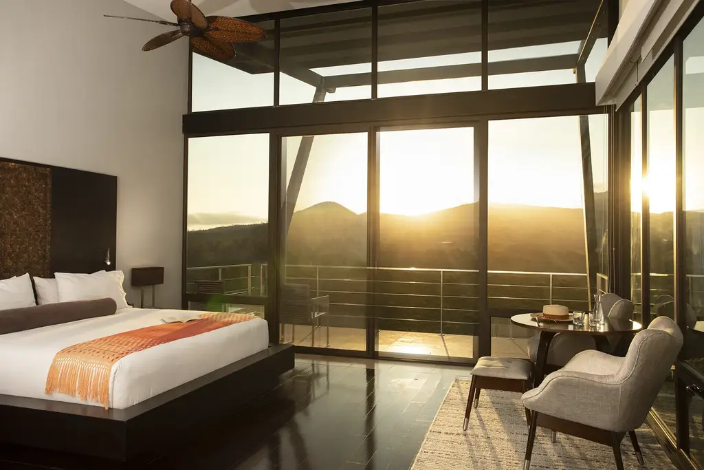 Balcony room with floor-to-ceiling windows overlooking the crater