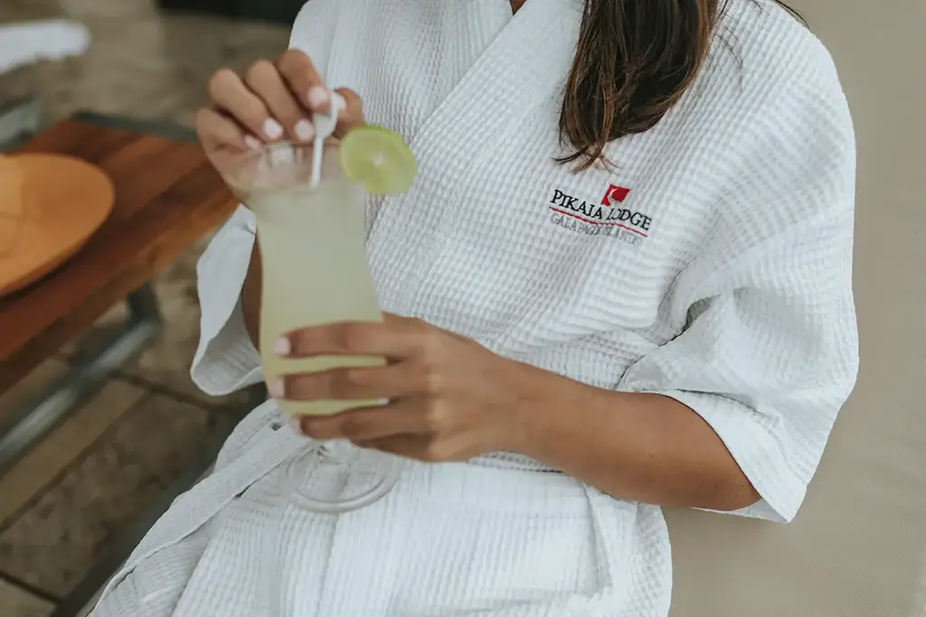 Pikaia Lodge spa robe and a fresh citrus drink
