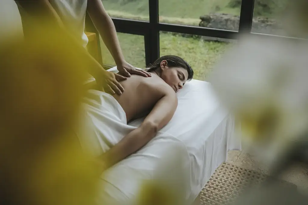 Back massage in a treatment room overlooking the hills